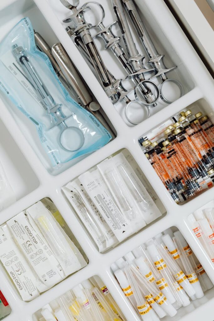 Close-up of syringes and medical supplies in a sterile laboratory setting, neatly arranged.