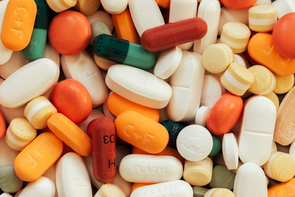 Close-up of assorted colorful pills and tablets on a surface.